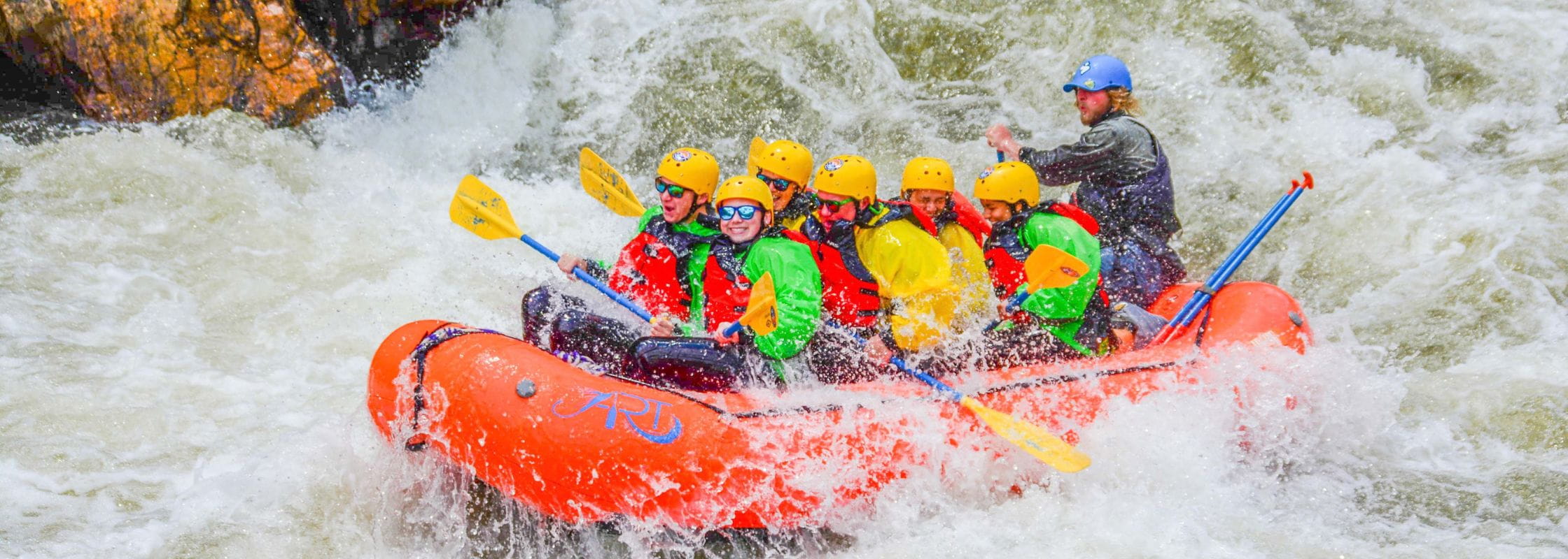 A raft going through a rapid on Upper Clear Creek in Colorado