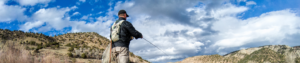Man stands in Arkansas river while wade fly fishing