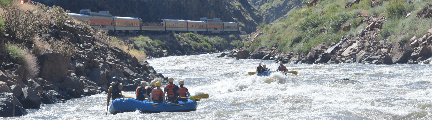 Royal Gorge Railroad next to Arkansas River with two rafts in water