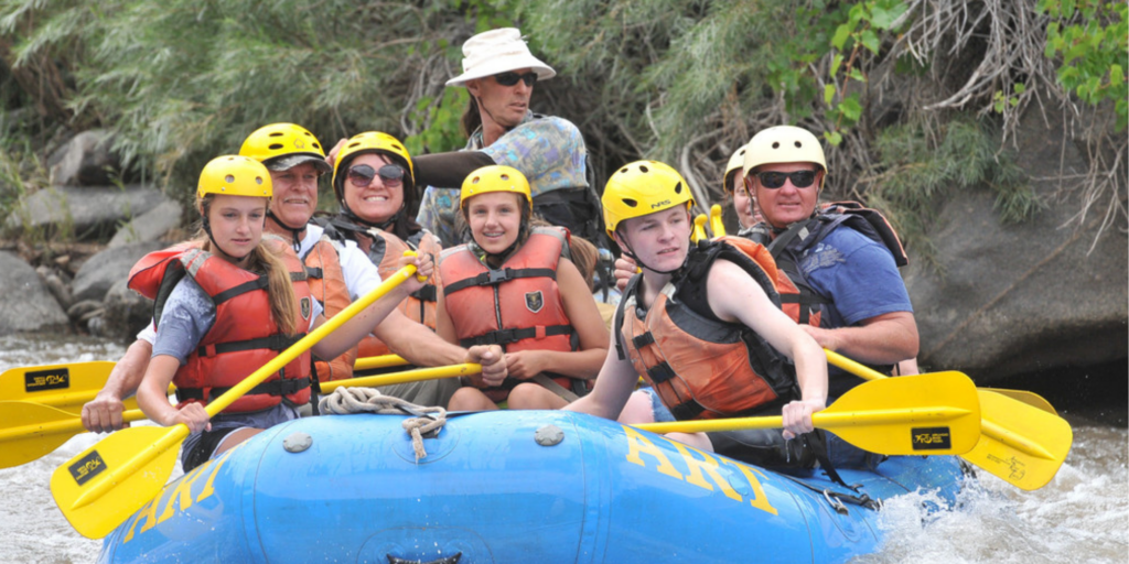 Happy guests with an ART river guide on the Arkansas river rafting trip