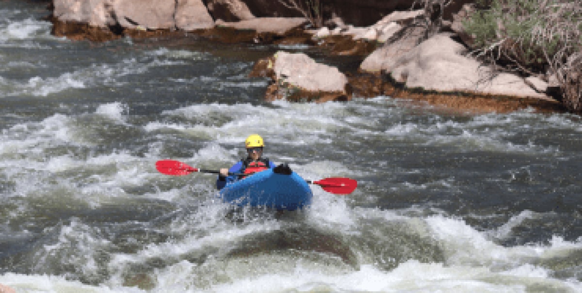 someone in an inflatable kayak